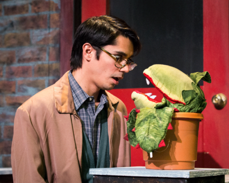 Seymour (Stephen Kanaski) meets Audrey II on Skid Row. (Photo by Michael Lodick)